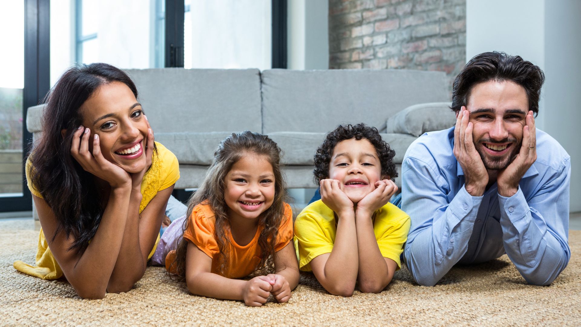 Smiling family on carpet in living room